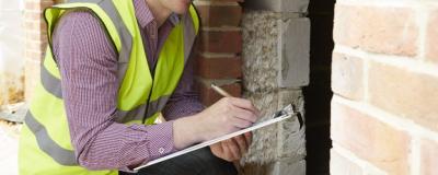 Inspector holding a clipboard performing an inspection.